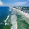 Aerial view of Jacksonville Beach with ocean waves and resorts in Florida.