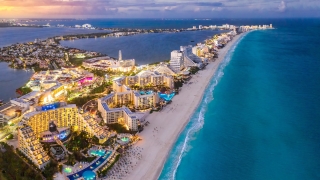 Aerial view of Cancún Hotel Zone at sunset.