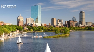 Boston skyline view with sailboats on the Charles River during a sunny day in Massachusetts