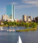 Boston skyline view with sailboats on the Charles River during a sunny day in Massachusetts