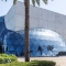 Dalí Museum in St. Petersburg, Florida, featuring a glass geodesic dome and palm trees.