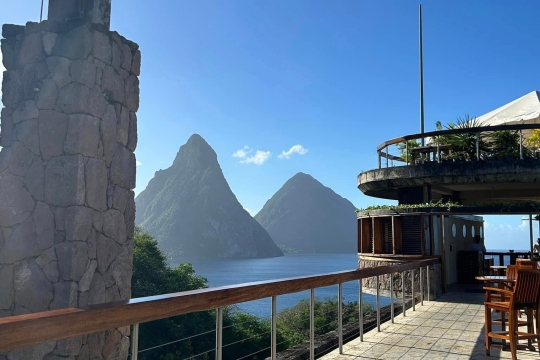 Scenic view of the Pitons mountains in St. Lucia from a resort terrace overlooking the Caribbean Sea.