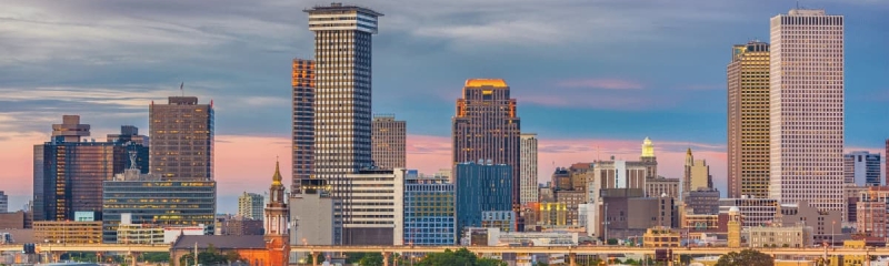 New Orleans downtown skyline at sunset with modern skyscrapers and colorful buildings