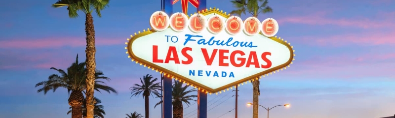 Famous Welcome to Fabulous Las Vegas sign at sunset with palm trees in Nevada
