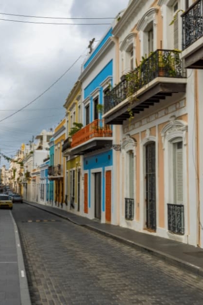 Colorful colonial buildings along a cobblestone street in Old San Juan, Puerto Rico.