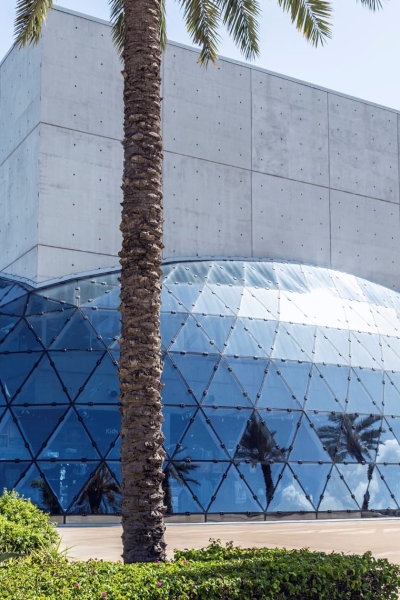 Dalí Museum in St. Petersburg, Florida, featuring a glass geodesic dome and palm trees.