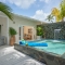 Private Pool Villa in St. Lucia – Tropical courtyard with plunge pool and waterfall feature at a Caribbean resort.