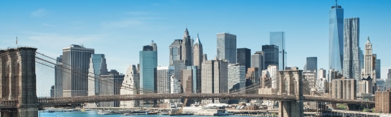 Brooklyn Bridge and New York City skyline with One World Trade Center on a sunny day