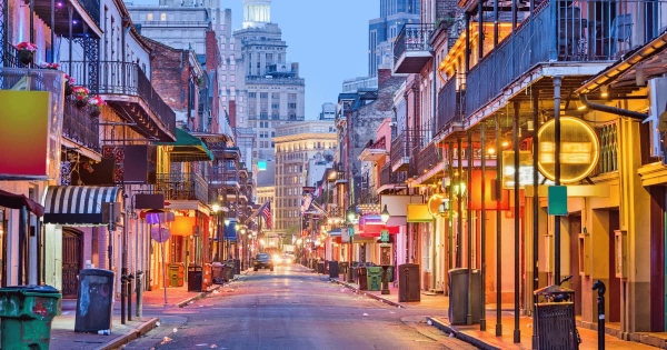 Colorful Bourbon Street in the French Quarter of New Orleans, Louisiana, with neon lights and historic balconies